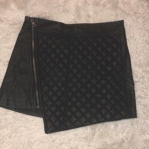 Asymmetrical black leather skirt.